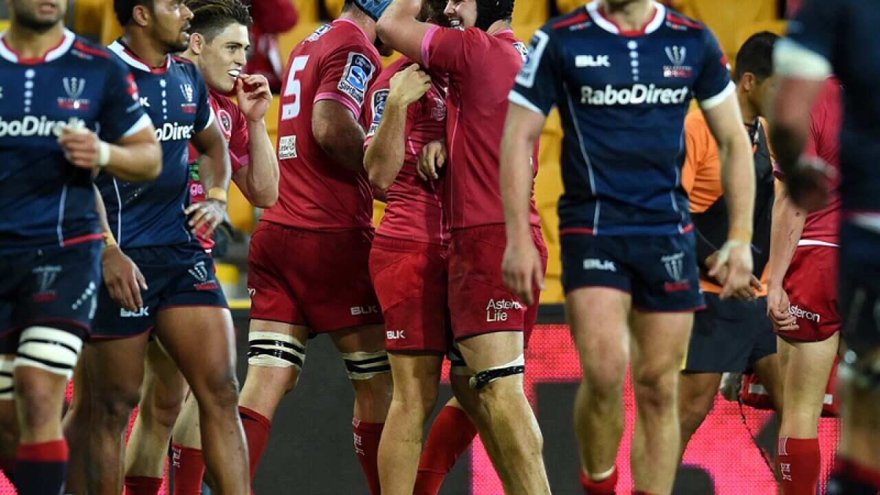 Queensland Reds players celebrate a try against the Melbourne Rebels
