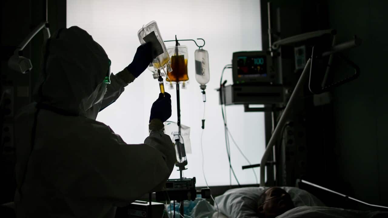 An employee and a patient at an intensive care unit