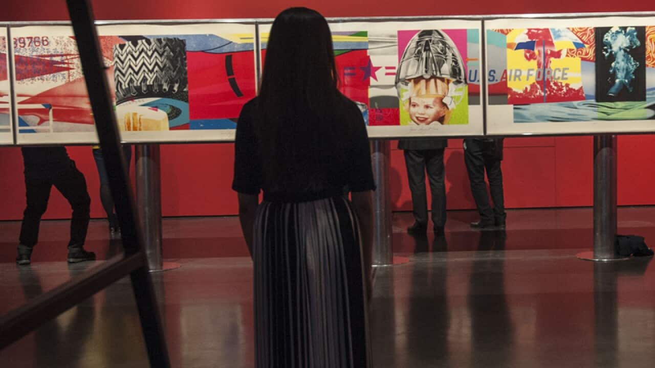 A member of staff observing F-111 1974 by James Rosenquist