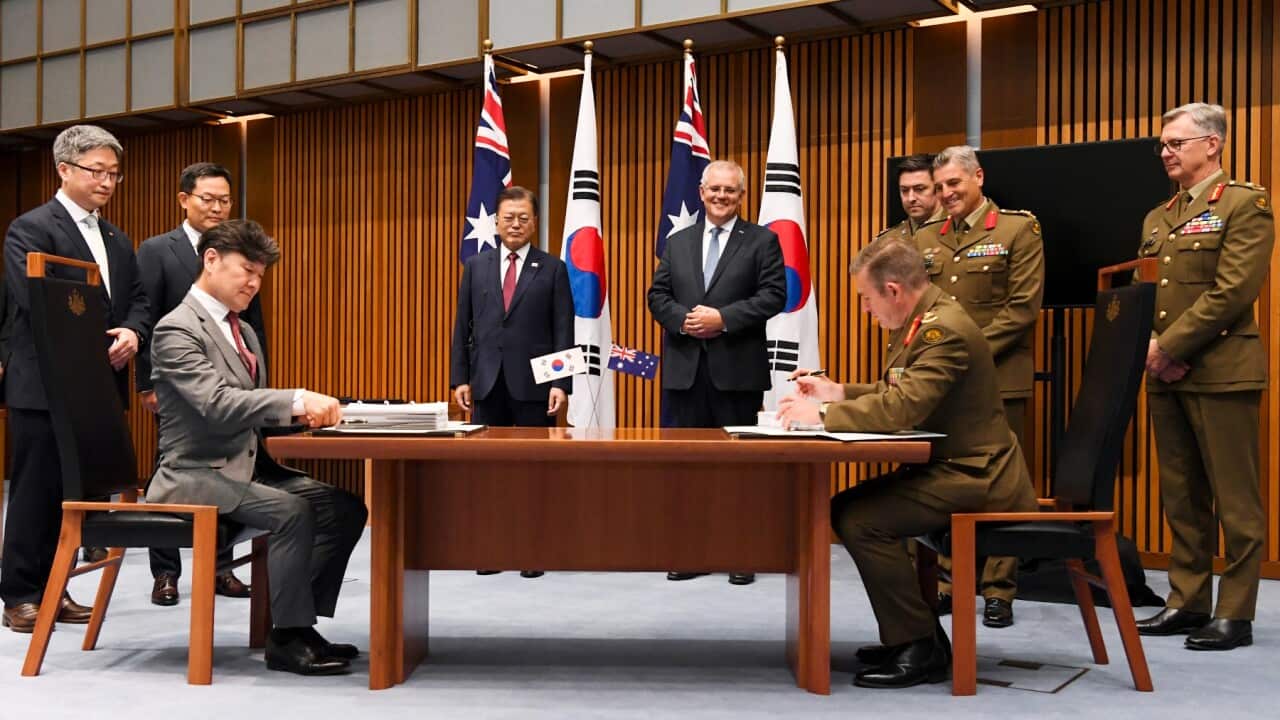 South Korean President Moon Jae-in, Australian PM Scott Morrison and the members of the Australian Defence Force during a signing ceremony at Parliament House, in Canberra, Australia, Monday, Dec. 13, 2021.