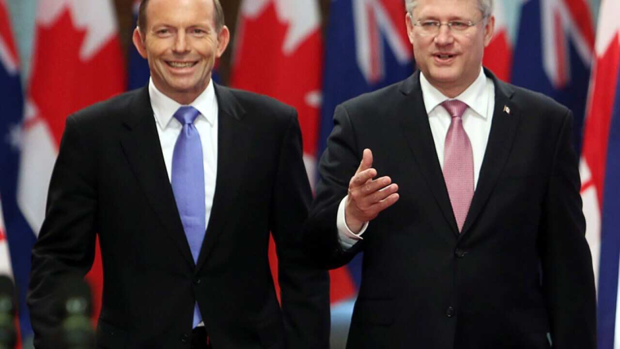 Tony Abbott (L) and Canadian Prime Minister Stephen Harper
