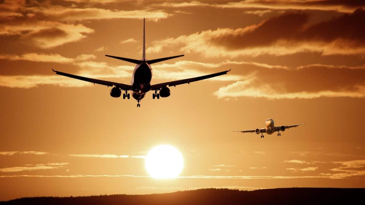two airplanes fly in a sepia sky