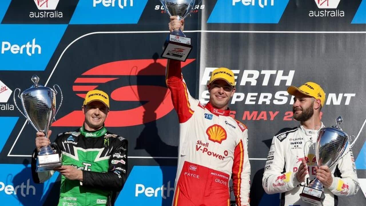 Scott McLaughlin holds up his trophy.