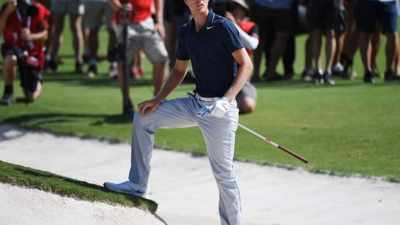 Cameron Davis of Australia stands after playing a shot from a bunker
