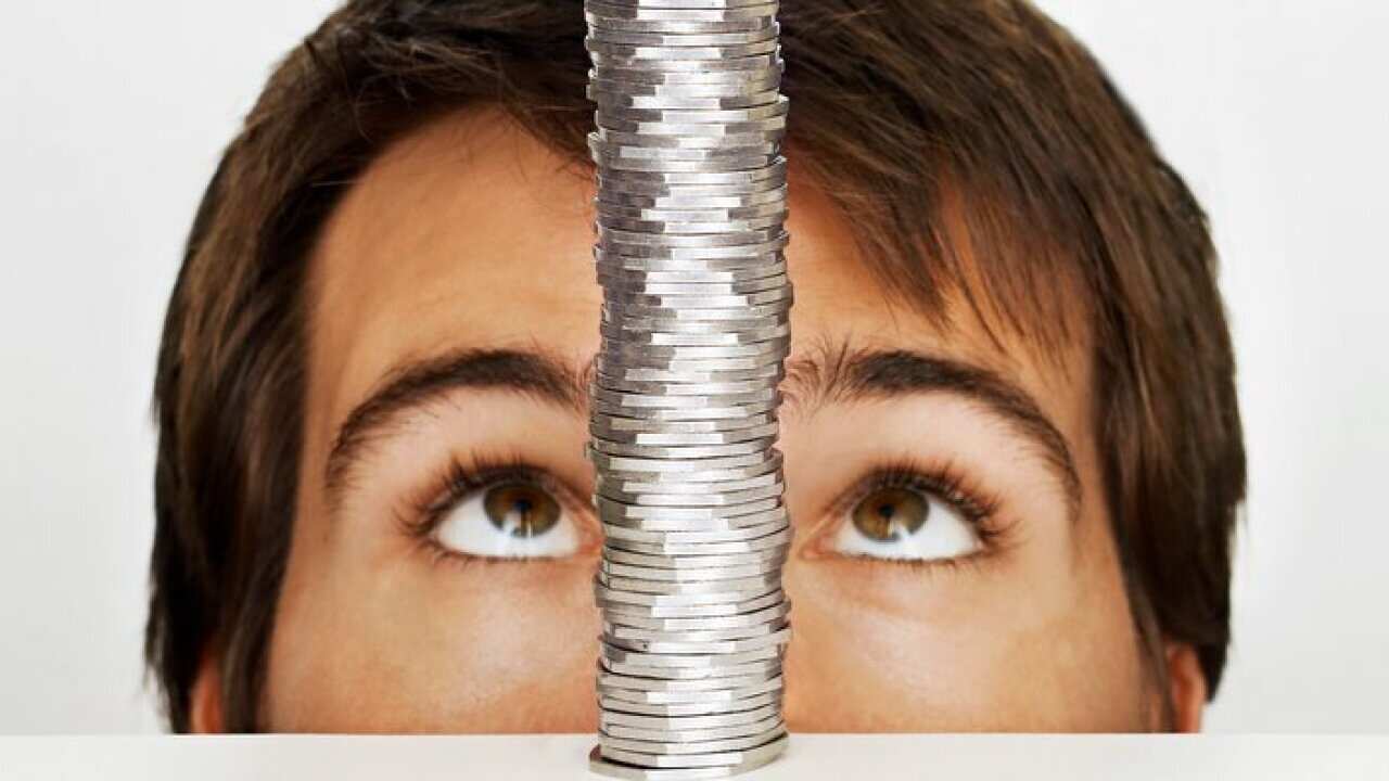 Man looking at stack of coins