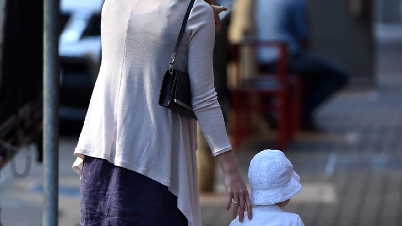 A woman and a child walking in Brisbane