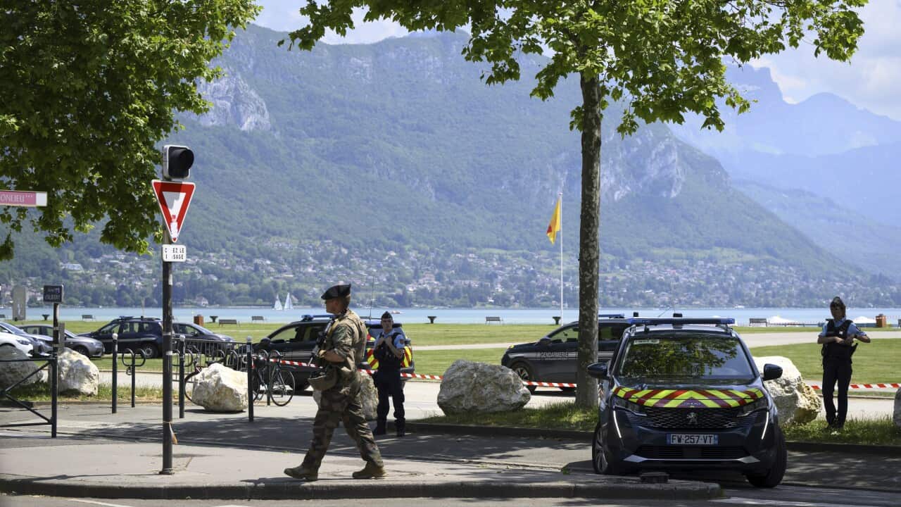 Police gather in a park in the French alps