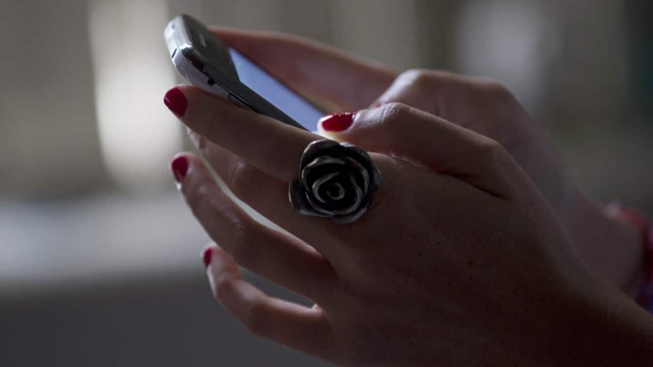 A woman uses a smartphone.