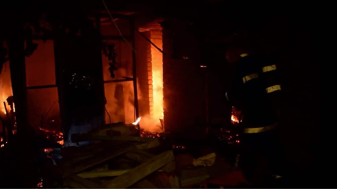 Firefighters and rescue crews battling fires in the aftermath of Russian rocket strikes on the Black Sea port city of Mykolaiv (AP).jpg