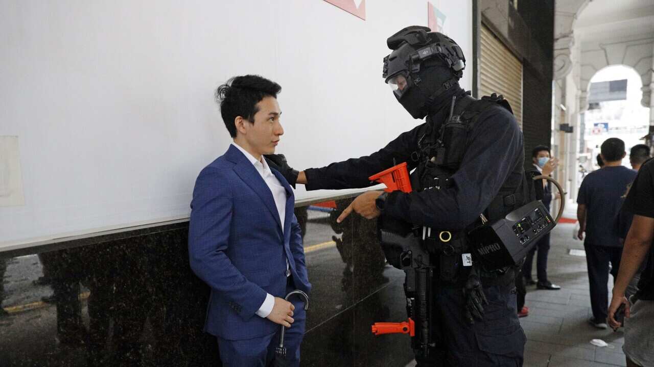 A pedestrian and a police officer in Hong Kong this week