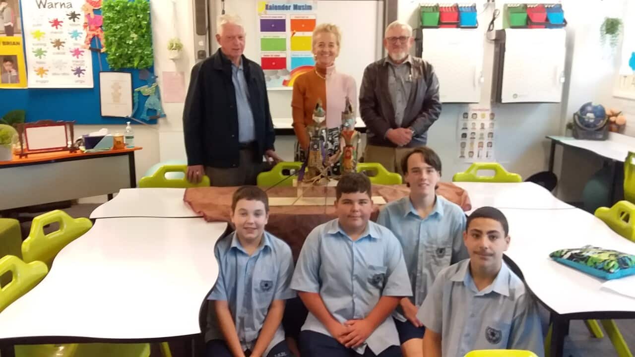 Michael Kramer (R) from AIA NSW donates wayang golek