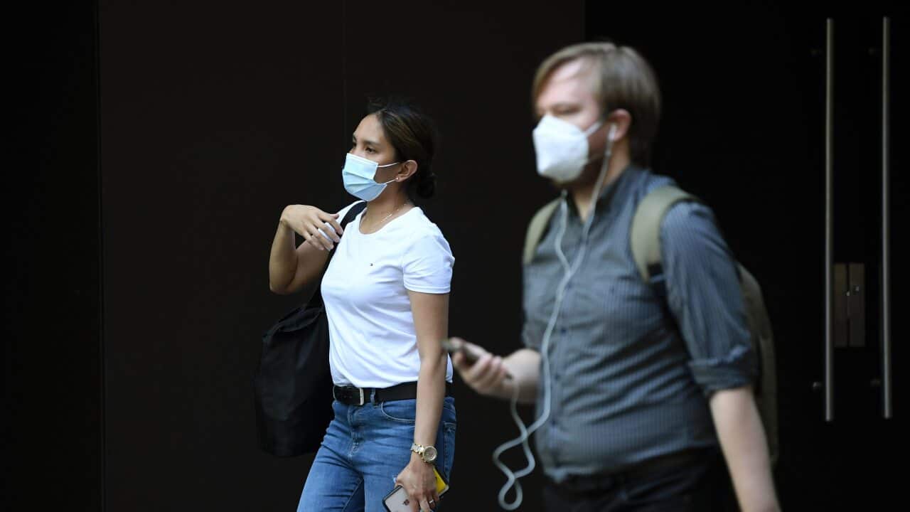 Pedestrians wearing a face mask in Sydney, Monday, January 18, 2021. NSW reported six new local cases of COVID-19 on Sunday, five of which were household contacts of a previously-confirmed case in western Sydney. (AAP Image/Joel Carrett) NO ARCHIVING
