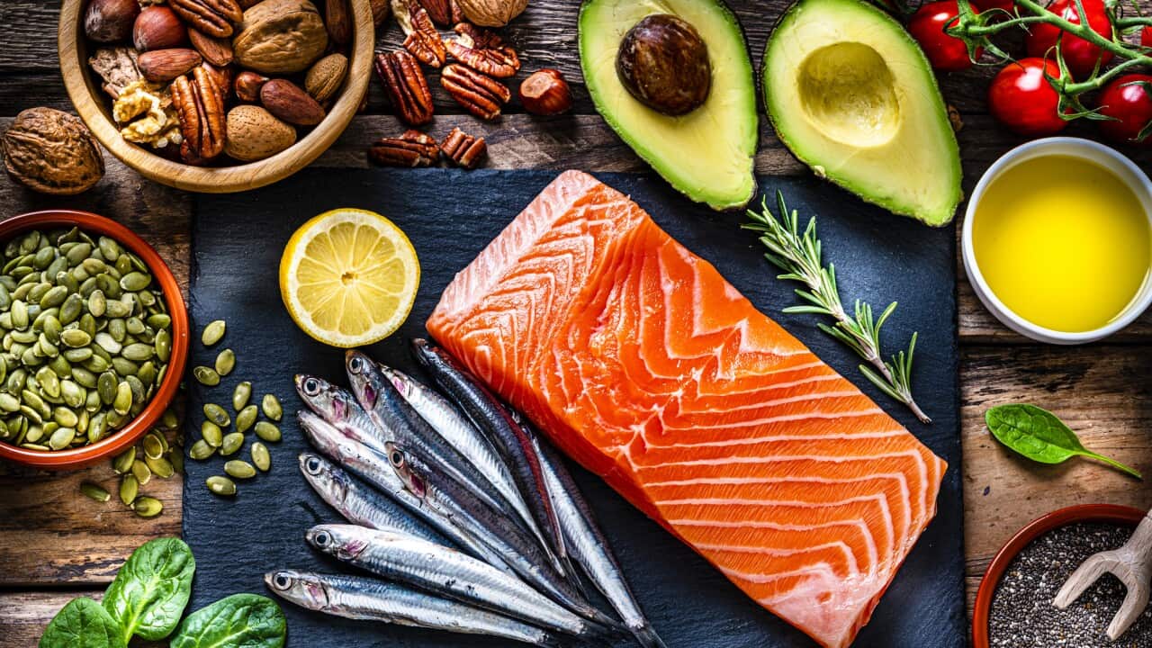 Brain food: overhead view of a group of food with high levels of Omega-3 fat. The composition includes salmon, sardines, avocado, extra virgin olive oil, and various nuts and seeds like pumpkin seeds, chis seeds, pecan, almonds, pistachio, walnuts and hazelnuts. High resolution 42Mp studio digital capture taken with Sony A7rII and Sony FE 90mm f2.8 macro G OSS lens