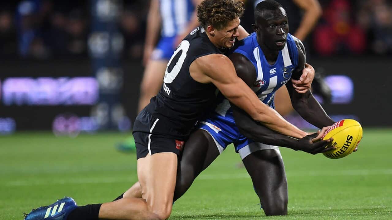 Majak Daw, right, and Carlton's Charlie Curnow
