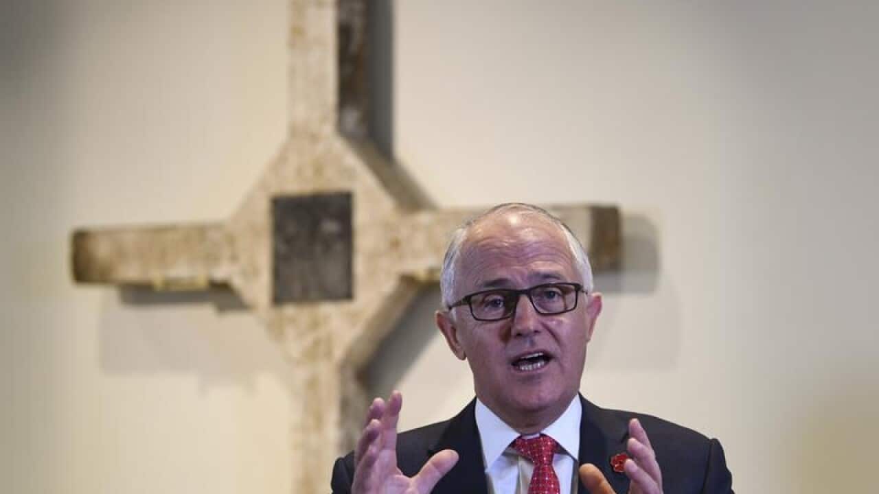 Malcolm Turnbull speaks in front of the Long Tan Cross