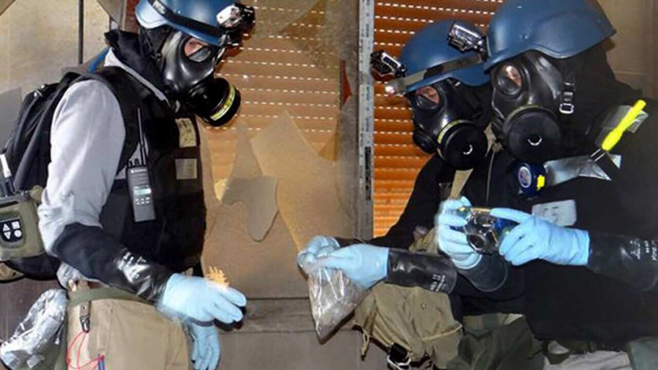 investigation team take samples from the ground near Damascus.