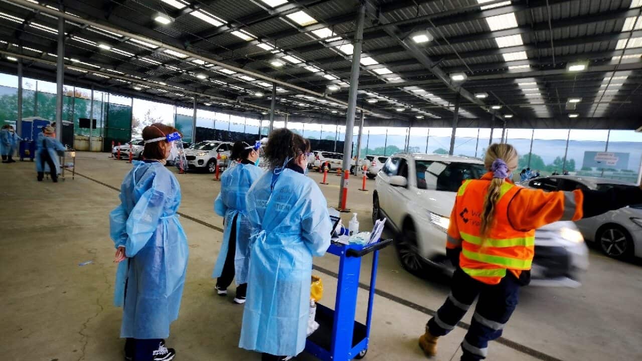 Health workers at a drive-through COVID-19 vaccine hub in Melton in Melbourne on 9 August 2021.