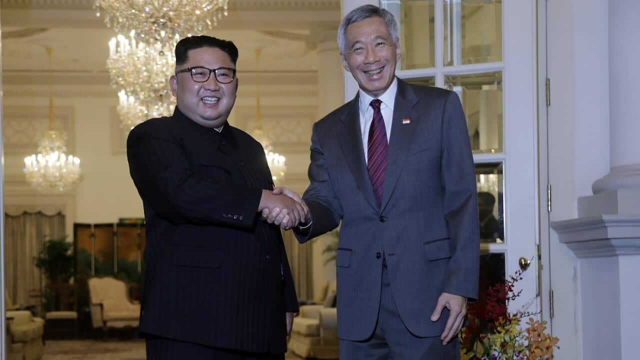 North Korean leader Kim Jong-un meets with Singapore's Prime Minister Lee Hsien Loong at the presidential palace.