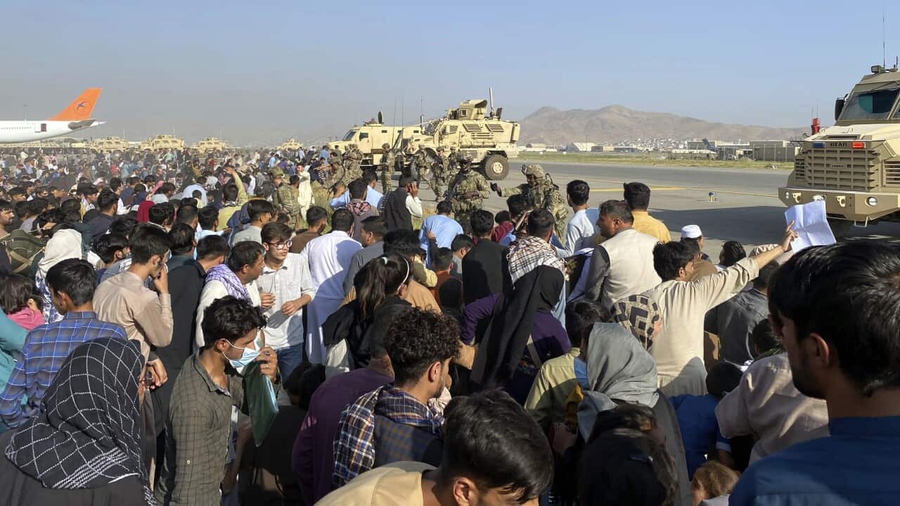 U.S soldiers stand guard inside the international airport in Kabul, Afghanistan, Mon, Aug. 16, 2021