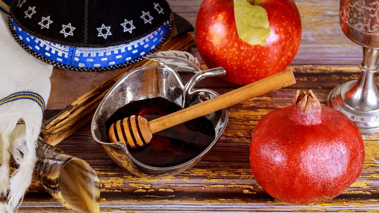 Shofar and tallit with glass honey jar and fresh ripe apples. Jewesh new year symbols. Rosh hashanah