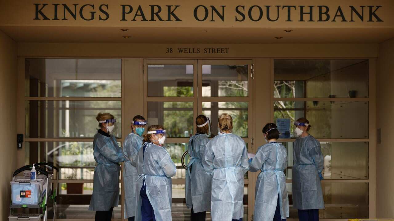 COVID testing staff enter the Kings Park on Southbank apartment building, in Melbourne, Tuesday, June 15, 2021.