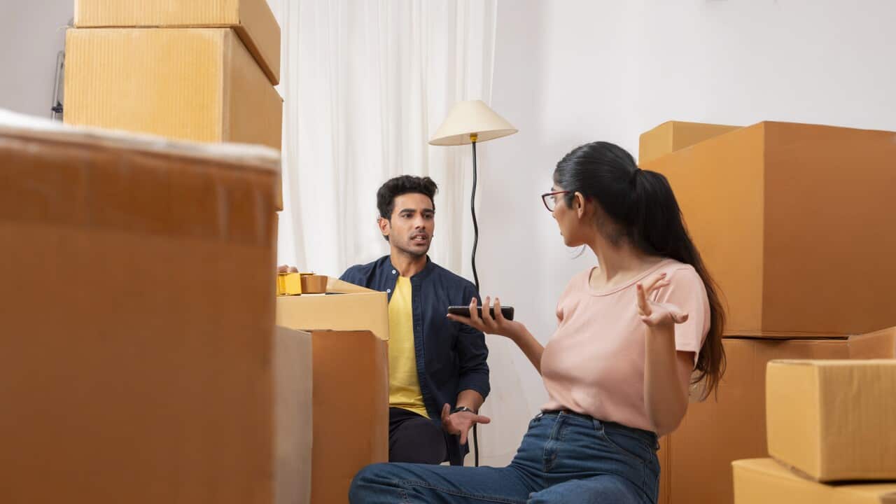 Adult boy and girl talking with each other during packing