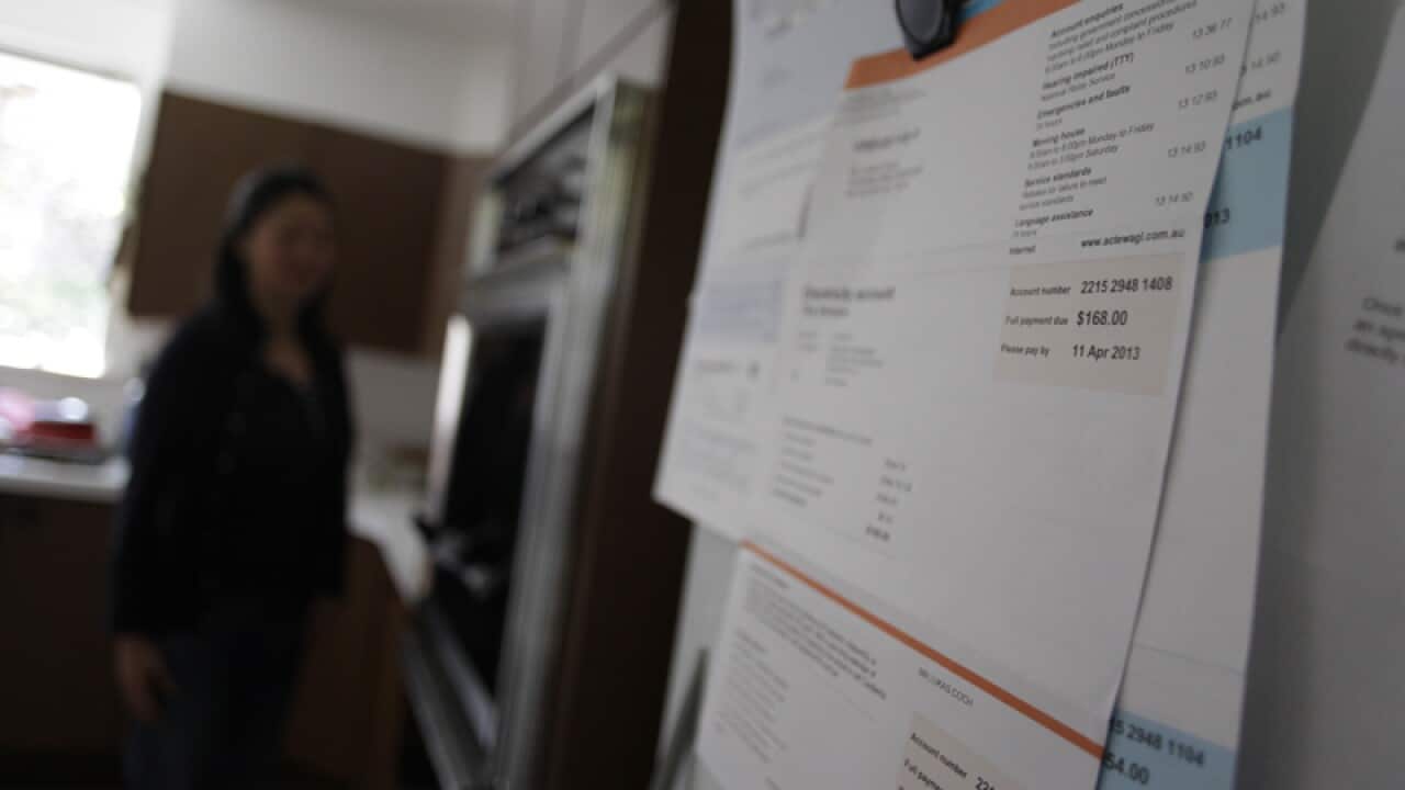 Bills are seen hanging on a fridge