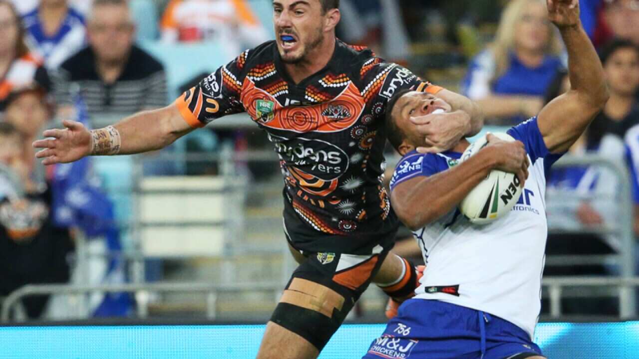 Wests Tigers fullback Justin Hunt tackled Canterbury's Moses Mbye