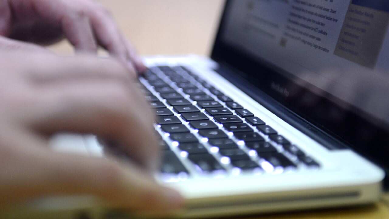 A man uses a laptop computer