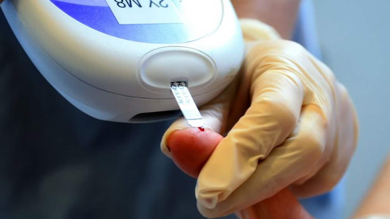 Nurse giving a patient a diabetes test