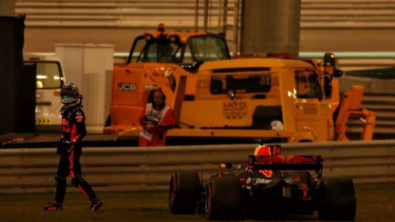 Daniel Ricciardo walks away from his Red Bull Racing vehicle.