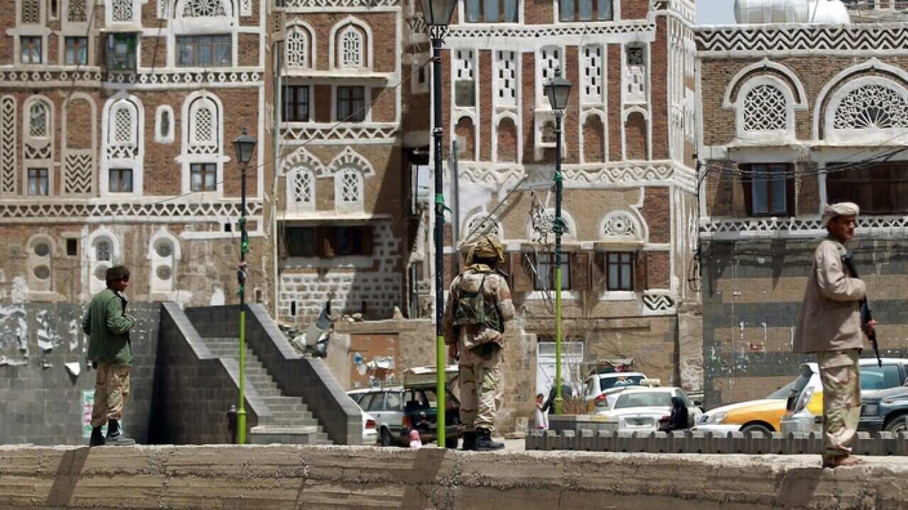 Armed Shiite Huthi rebels stand guard in the old city of the Yemeni capital Sanaa