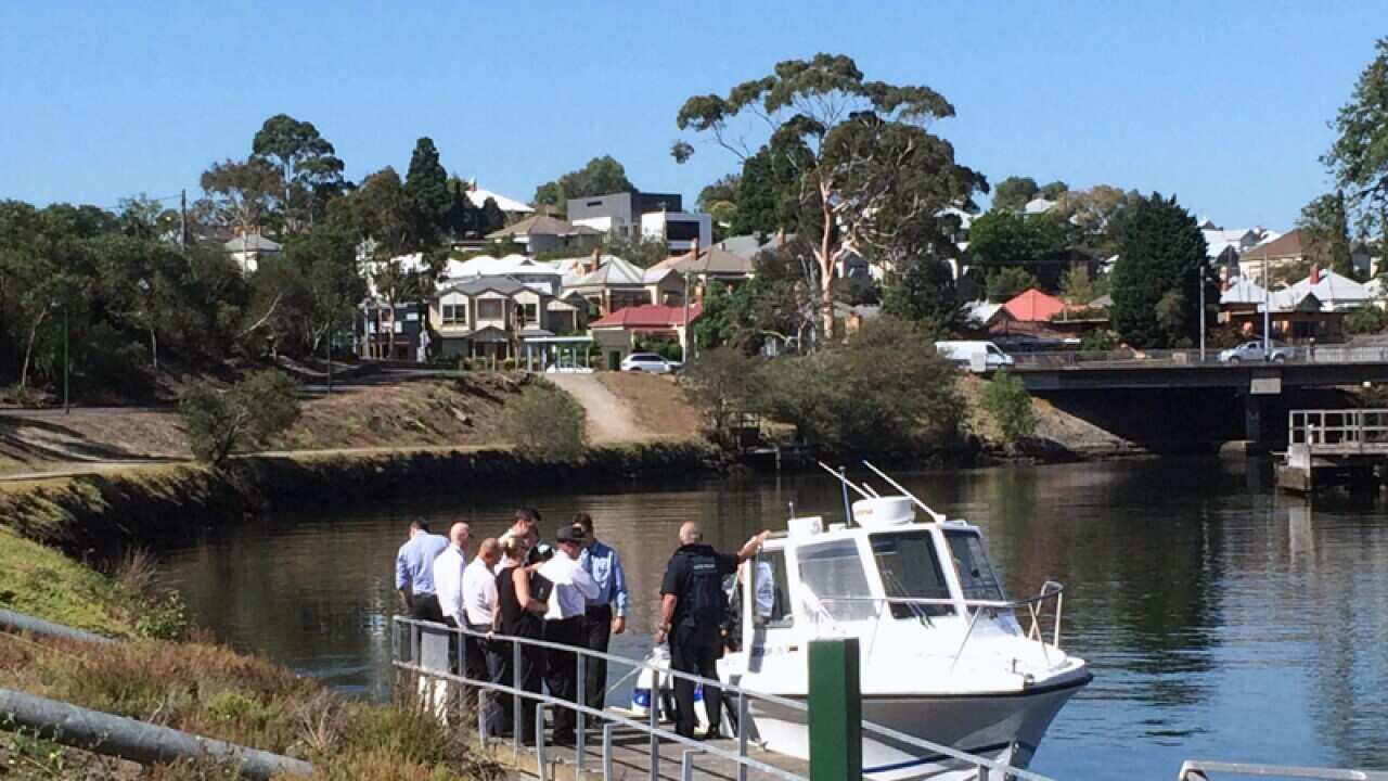 Detectives search a Melbourne river for body parts.