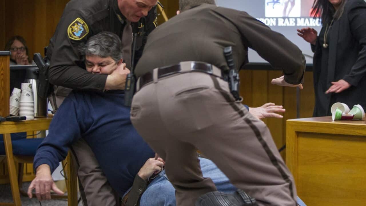 Eaton County Sheriff's deputies restrain Randall Margraves, father of three victims of Larry Nassar, Friday, Feb. 2, 2018, 