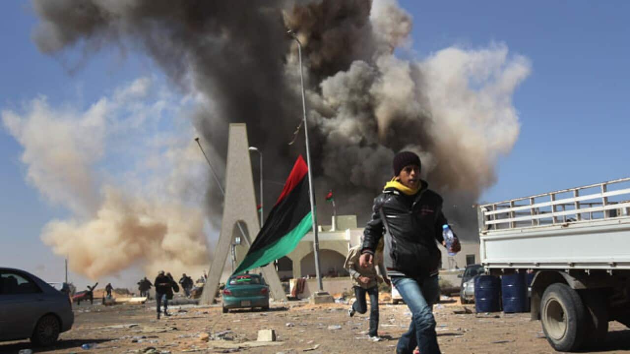 libya_rebel_flees_pro-Gaddafijet_airstrike2_B_getty_110322_1134454708