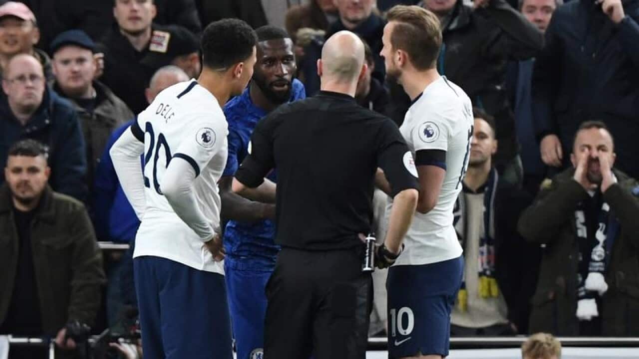The referee speaks to Chelsea's Antonio Rudiger