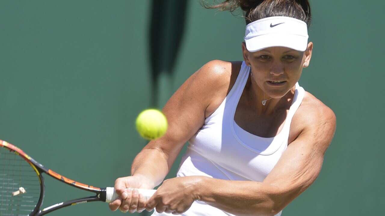 Casey Dellacqua of Australia returns to Tamira Paszek of Austria