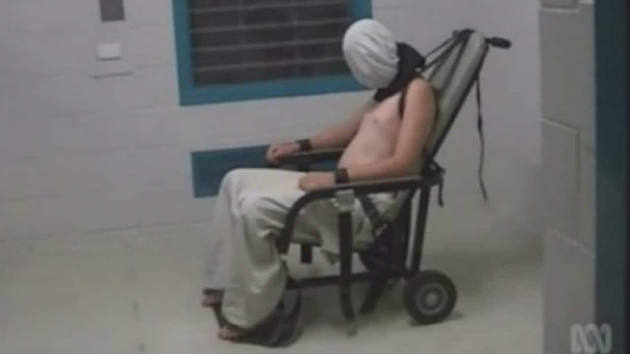 Still image of Dylan Voller, hooded and restrained in 2016