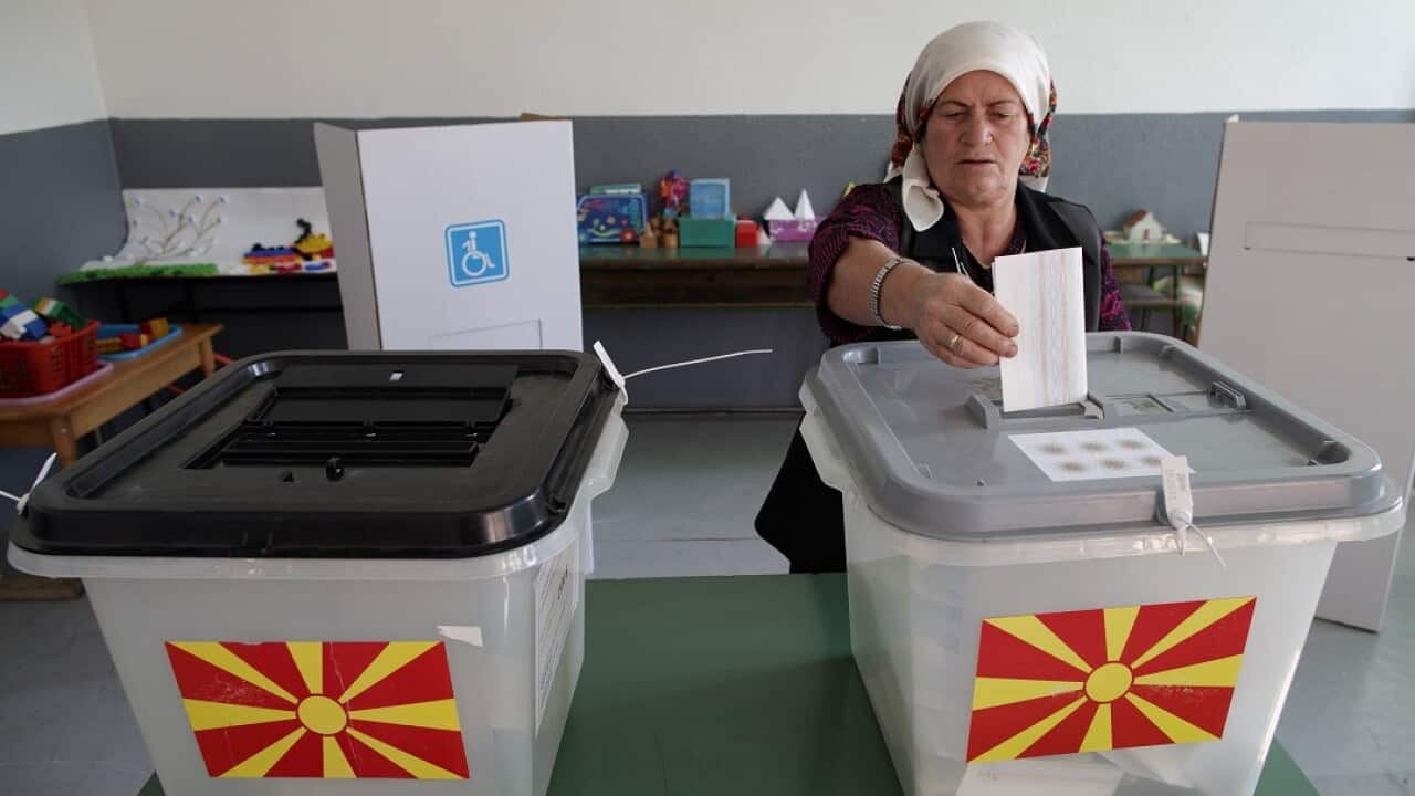 An Albanian woman casts her vote in a referendum on the country's name change at a polling station in the village of Zajas.