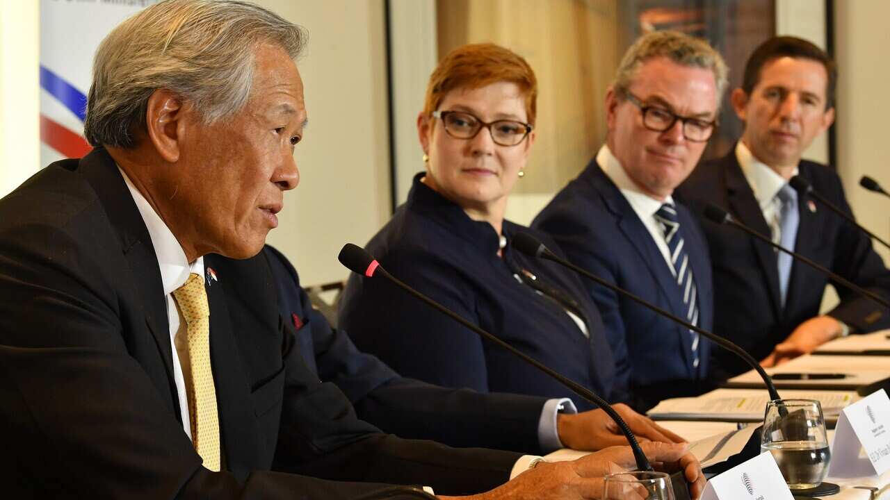 Australian ministers Marise Payne, Christopher Pyne and Simon Birmingham listen to Singapore's Defence Minister Ng Eng Hen.