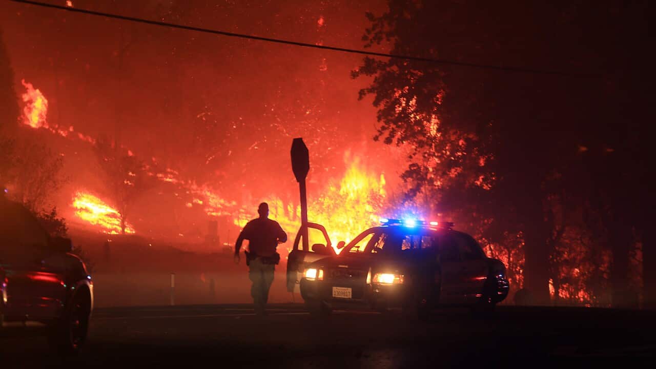 Lake County sheriff's officers prepare to evacuate Butts Canyon Road in Middletown, Calif., as the Valley fire jumps Hwy 29, Saturday, Sept. 12, 2015. (Kent Porter/The Press Democrat via AP)