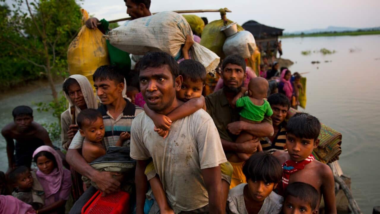 Rohingya Muslims carry their young children and belongings after crossing the border from Myanmar into Bangladesh. Some of them will be heading back.