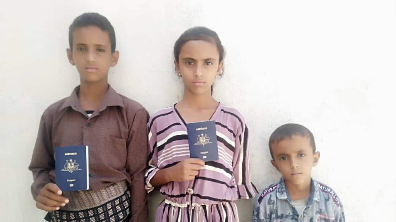 Ahmed's kids with passports2.jpg