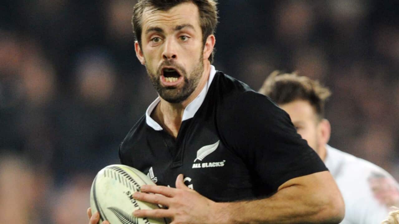 Conrad Smith runs with the ball.