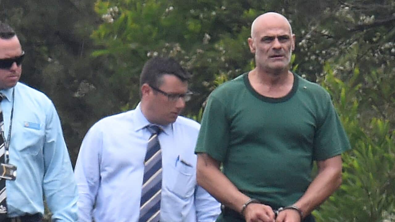 NSW Police escort Vinzent Tarantino (right) south of Sydney, 23 November 2016. 