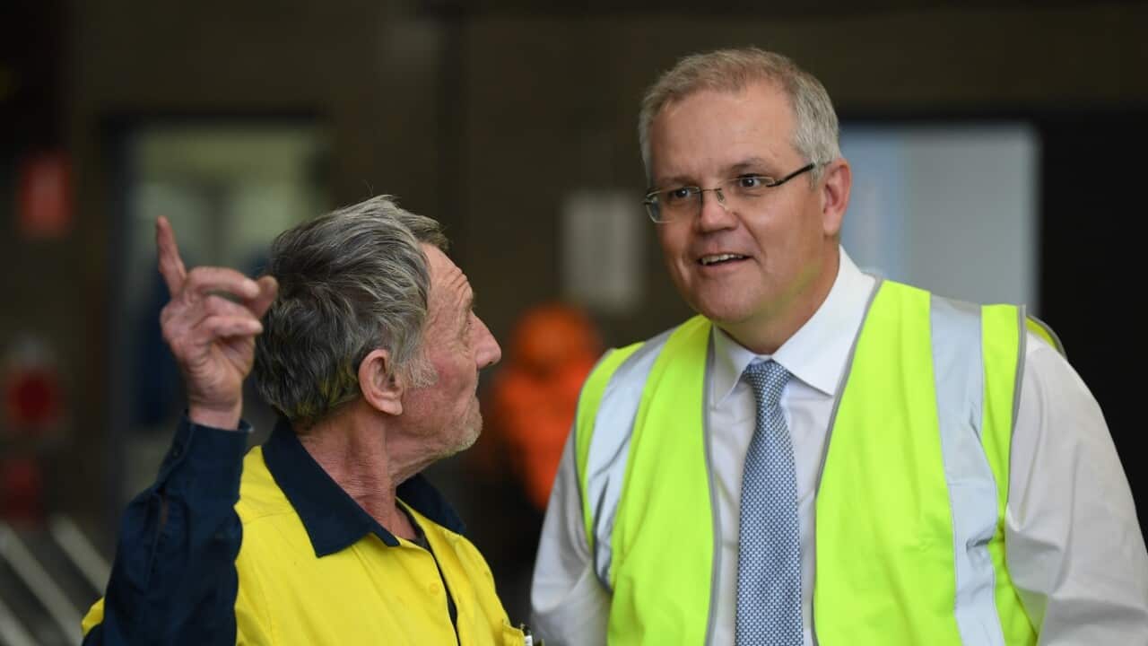 Australian Prime Minister Scott Morrison (right) talks to employee Michael Sheridan (left) during a visit to steel manufacturing business Galvatech