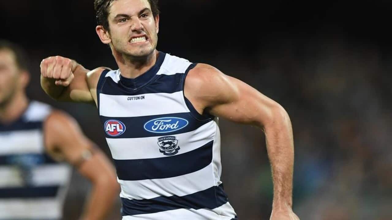 Daniel Menzel of the Cats reacts after kicking a goal.