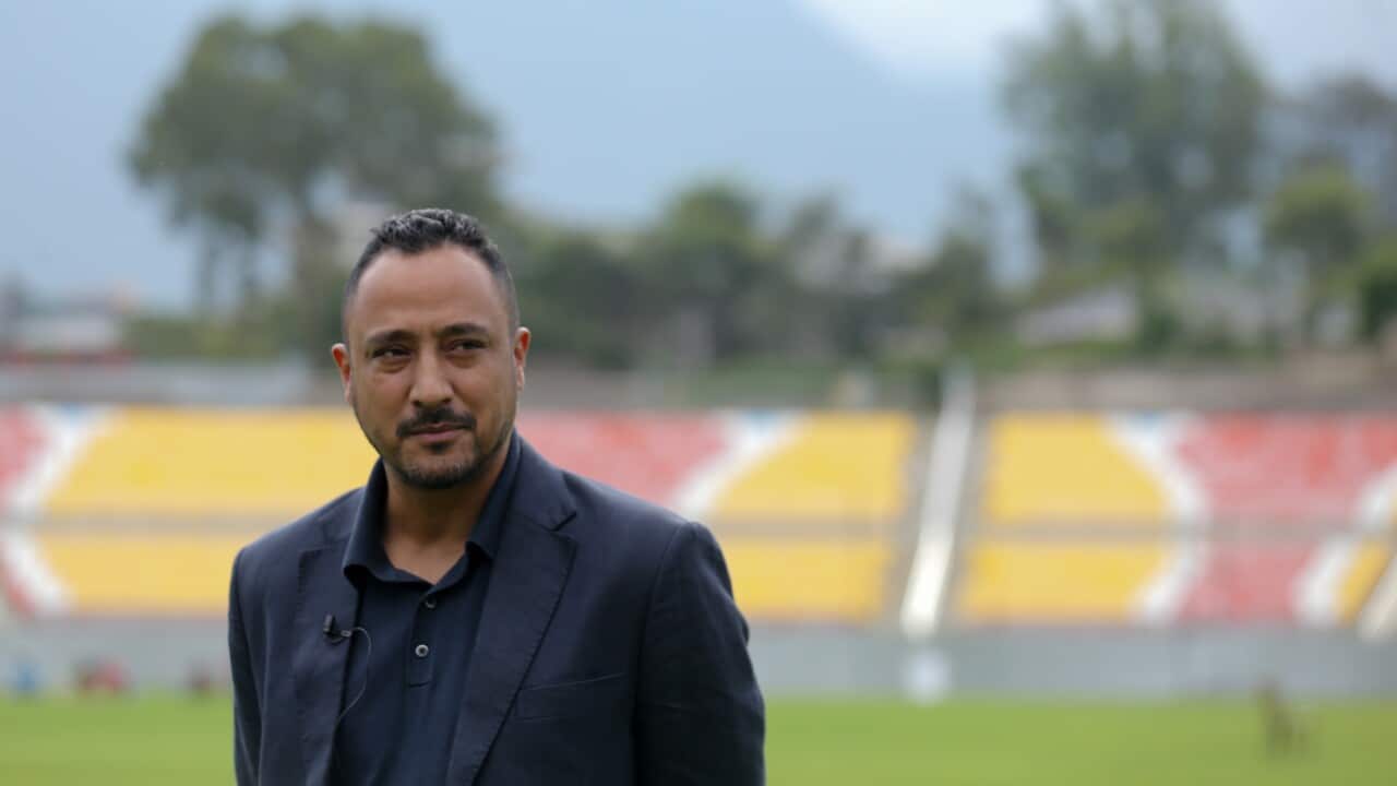 Paras Khadka, Secretary of the Cricket Association of Nepal (CAN), is pictured against the backdrop of the Tribhuvan University (TU) Cricket ground in Kathmandu, Nepal, on September 18, 2025.