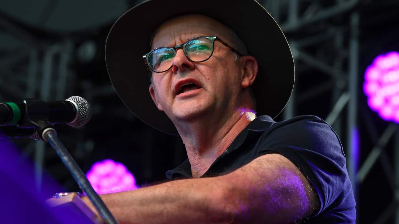 Anthony Albanese wearing an Akubra hat delivers a speech at the podium.