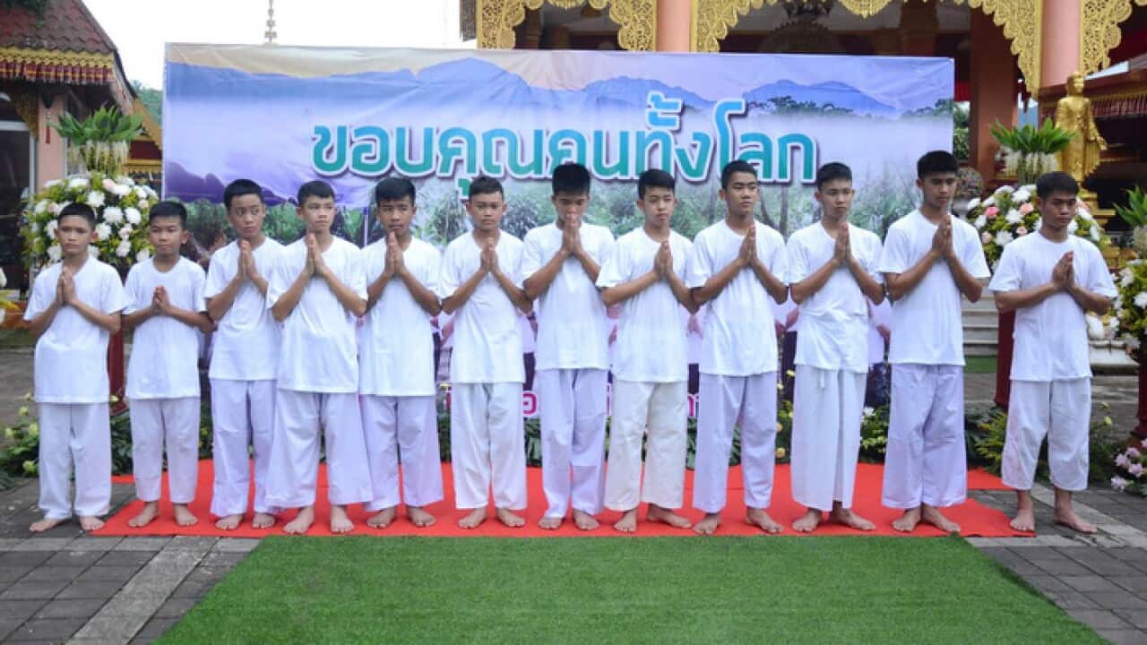 Members of Wild Boar football team and their assistant coach Ekapol Chantawong (right), who were rescued from the Tham Luang cave.